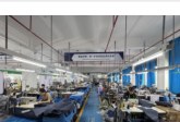 Robotic arm working on a luggage production line